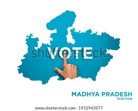 VOTE FOR INDIA MADHYA PRADESH , male Indian Voter Hand with voting sign or ink pointing out , Voting sign on finger tip Indian Voting on blue background Royalty-Free Stock Photo #1932942077