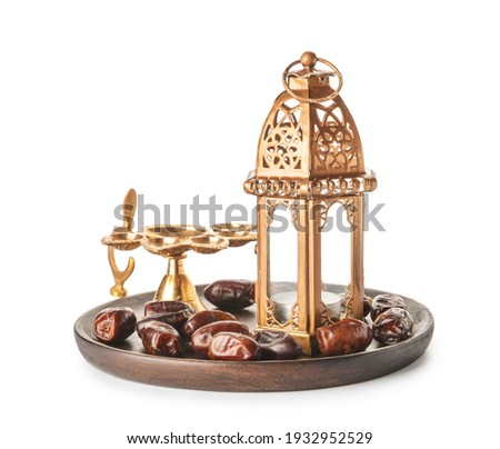 Muslim lamp and dates on white background Royalty-Free Stock Photo #1932952529