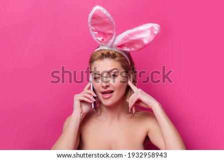 Funny Easter bunny woman calling with cell phone