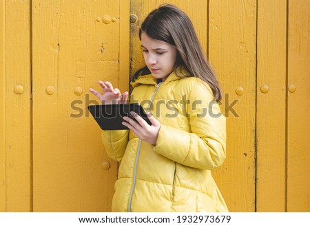 Portrait of a Caucasian girl consulting her tablet