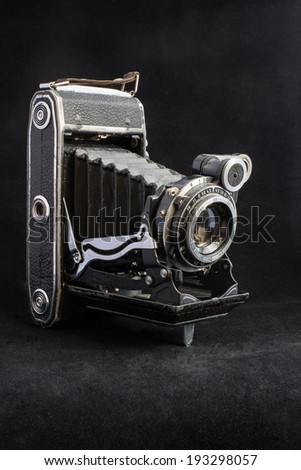 Very old film camera on dark background