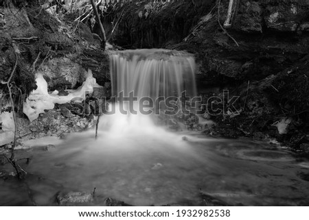 Skujenieku waterfall in winter black and white