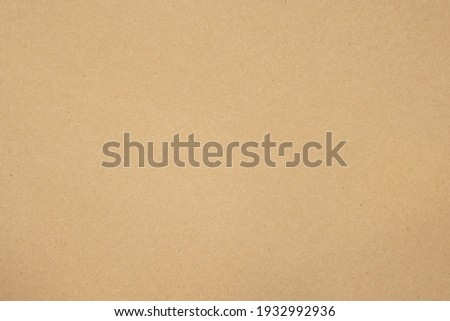 Texture of brown craft or kraft paper background, cardboard sheet, recycle paper, copy space for text. Royalty-Free Stock Photo #1932992936