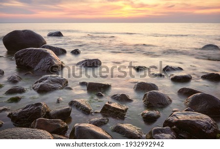 Rocky beach at a beautiful sunset, long exposure picture.