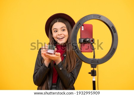 happy teen girl blogger use selfie led lamp and smartphone on tripod for making online video tutorial beauty blog presenting makeup cosmetics, beauty. Royalty-Free Stock Photo #1932995909
