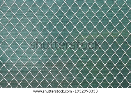 White Painted Wire Fence with Green Plastic Screen in Close Up 