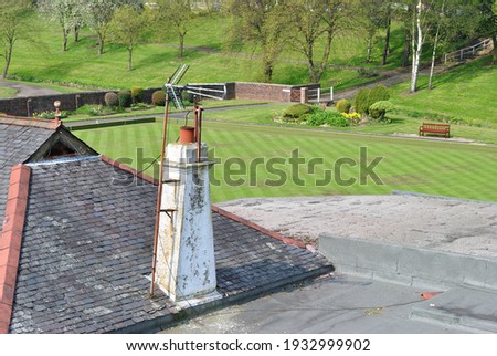 Television Aerials on Old Rooftop Chimney Stack  with Distant Bowling Green 