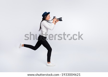 Full body profile side photo of happy young woman run empty space take picture paparazzi isolated on grey color background