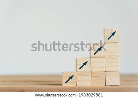 On table arrow go up on wood block stacking same as step stair background, Business growth up concept. copy space for text. Abstract Success stock market . management achievement. copy space