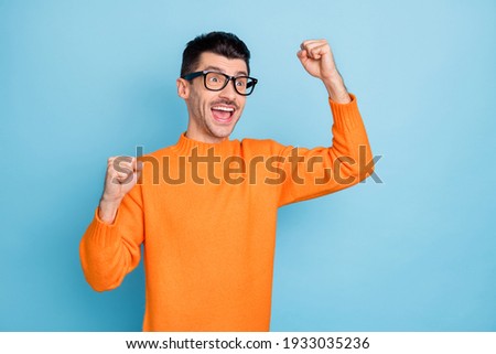 Profile portrait of astonished person fists up open mouth unbelievable result isolated on blue color background