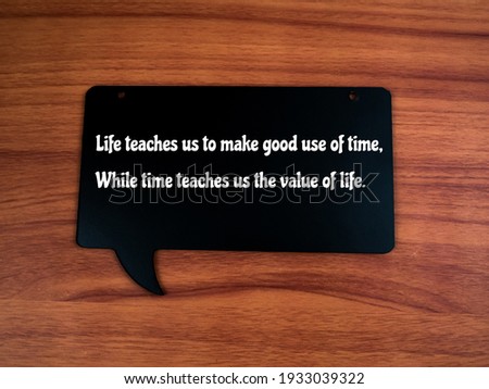 Motivational quotes at wooden craft written a "Life teaches us to make good use of time, While time teaches us the value of life".