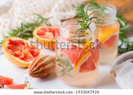 Hard seltzer cocktail with grapefruit and rosemary Royalty-Free Stock Photo #1933047926