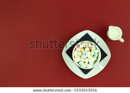 Cup of hot chocolate with marshmallows with place for text. Marshmallow with coffee in a white cup and saucer