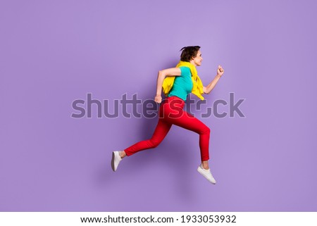Full length profile photo of lady jump run wear tied jumper t-shirt pants footwear isolated purple color background