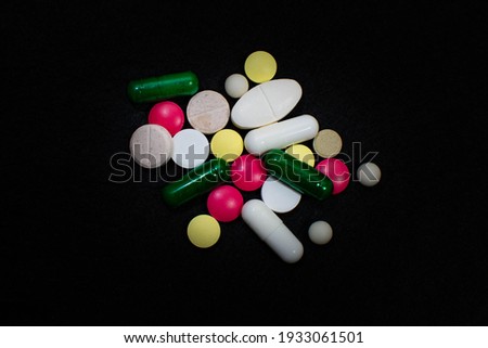 tablets and capsules on black