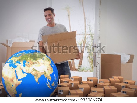 Composition of cardboard boxes with globe, man carrying box, unpacking in new home. moving house, global shipment and delivery concept digitally generated image.