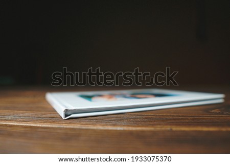 closeup of photobook corner on wooden table