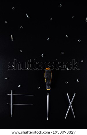Hardware with kit of small screwdrivers for fixing smartphones on black background.