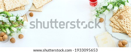 Pesah celebration concept (jewish Passover holiday). Traditional book with text in hebrew: Passover Haggadah (Passover Tale) Royalty-Free Stock Photo #1933095653