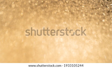 Beautiful abstract de-focused glitter vintage golden lights photo background. Christmas bokeh backdrop