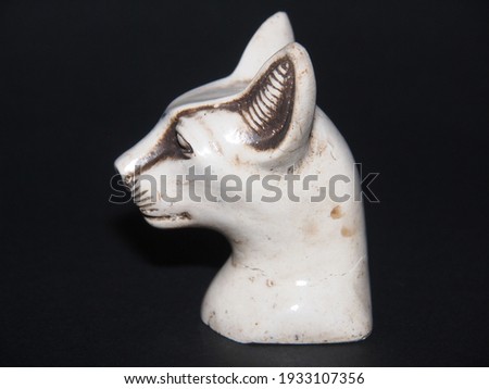 Egyptian style souvenir statue of the cat goddess isolated on a dark background