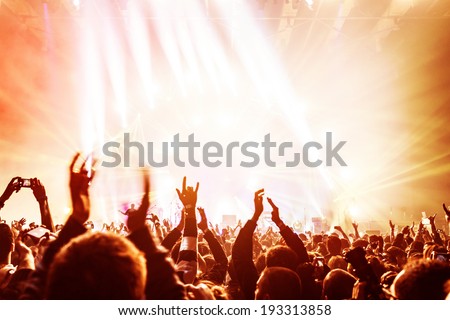 Crowd enjoying concert, happy people jumping, large group celebrating new year holiday, party background fun concept  Royalty-Free Stock Photo #193313858