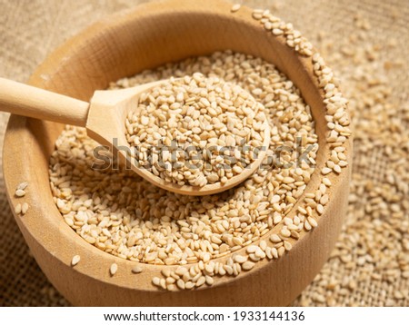 white sesame seeds, sesame seeds in a wooden spoon on an old rustic background close-up Royalty-Free Stock Photo #1933144136