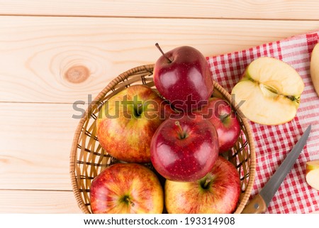 Fresh red apples in basket on wood. Whole background.