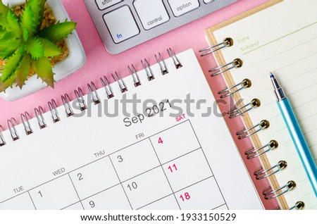 September 2021 calendar with note book on pink background. Royalty-Free Stock Photo #1933150529