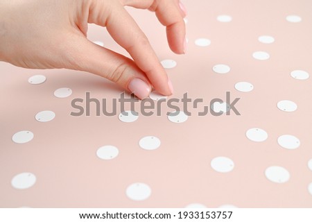 Women's hands take, on a beige background. High quality photo
