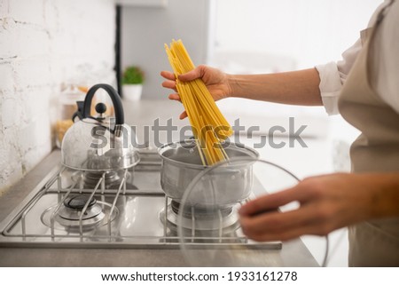Spaghetti. Close up picture of womans hands holding spaghetti
