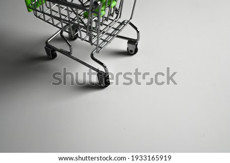Shopping cart on a dark background with shadows. High quality photo