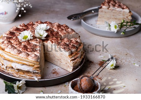 Tiramisu crepe cake with mascarpone and amaretto on a light background Royalty-Free Stock Photo #1933166870