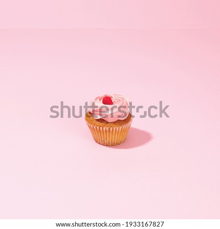 
This is a picture of a cupcake on a pink background.