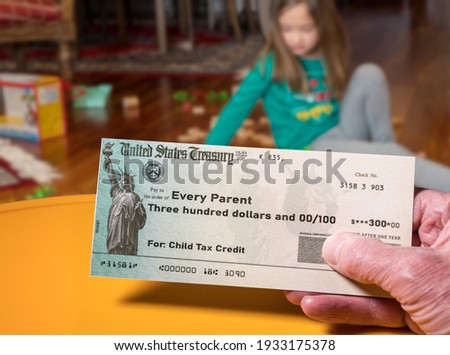 Mockup of US Treasury illustrative check for child tax credit for a small girl to illustrate American Rescue Plan Act of 2021 payments Royalty-Free Stock Photo #1933175378
