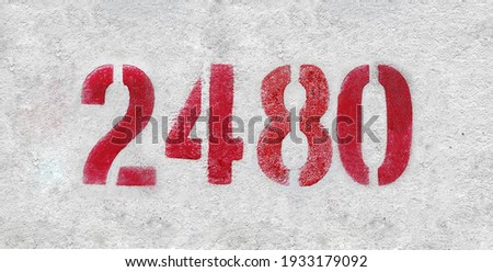 Red Number 2480 on the white wall. Spray paint.