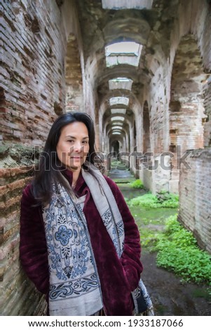 Portrait picture  with beautiful model in her late 50's at the Roman amphitheater with under passages in Santa Maria Capua Vetere, Capua- Campania, Italy.