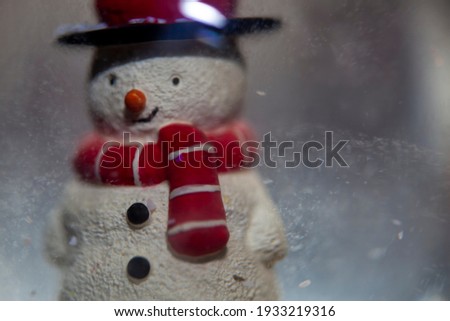 A Snowman inside a snowglobe.