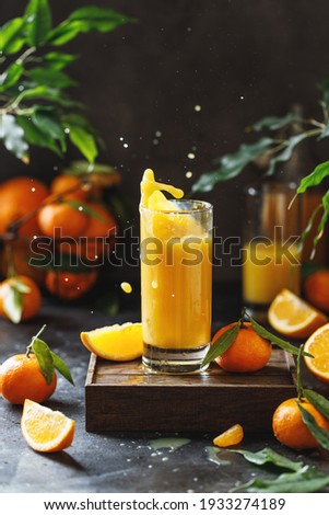 A glass of orange juice. Orange juice splash Royalty-Free Stock Photo #1933274189