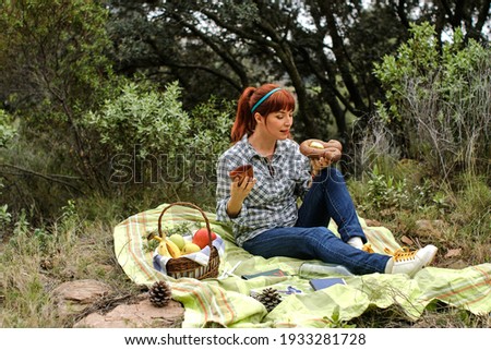 redhead woman having lunch in a picnic in spring