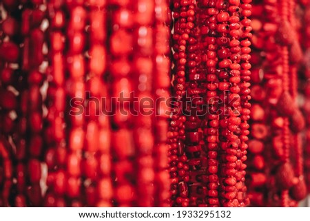 Red beads jewelry made of natural coral as a background texture. Copy, empty space for text.