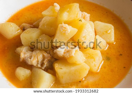 Close-up of a cooked plate of potatoes with cod in a vegetable sauce. Easy cooking recipes with fresh fish at home.