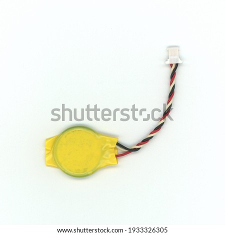 Cmos Bios battery for a laptop computer over white background Royalty-Free Stock Photo #1933326305