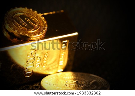 Plastic made toy gold bar coin and dollar coin scene represent business and finance concept related idea.