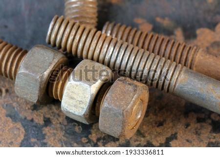 Artistic picture with rusty iron old bolts and nuts on rusty iron surface close-up macro photography