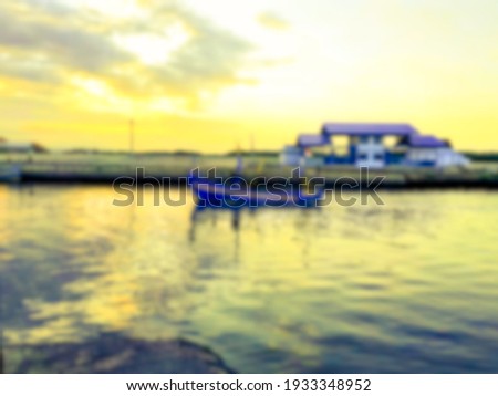 Blurred background of beautiful  port with a fisher boat  at sunset