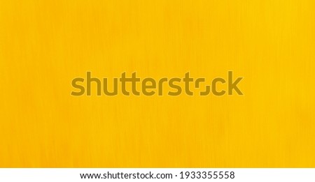 Rich egg yolk yellow coloured slightly textured background with copyspace