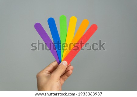 LGBTQ flag on gray background. LGBT gay pride rainbow colored stripes symbol.