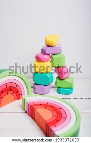 Wooden cubes with different faces for the development of coordination and balancing. Bright toys for children made of natural wood. Wooden rainbows in the form of a watermelon. Zero waste.
