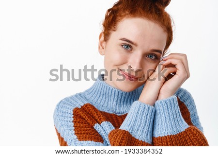 Close up portrait of beautiful redhead woman face with pale skin, no blemished and natural make up, smiling lovely and romantic, gazing at you, white background